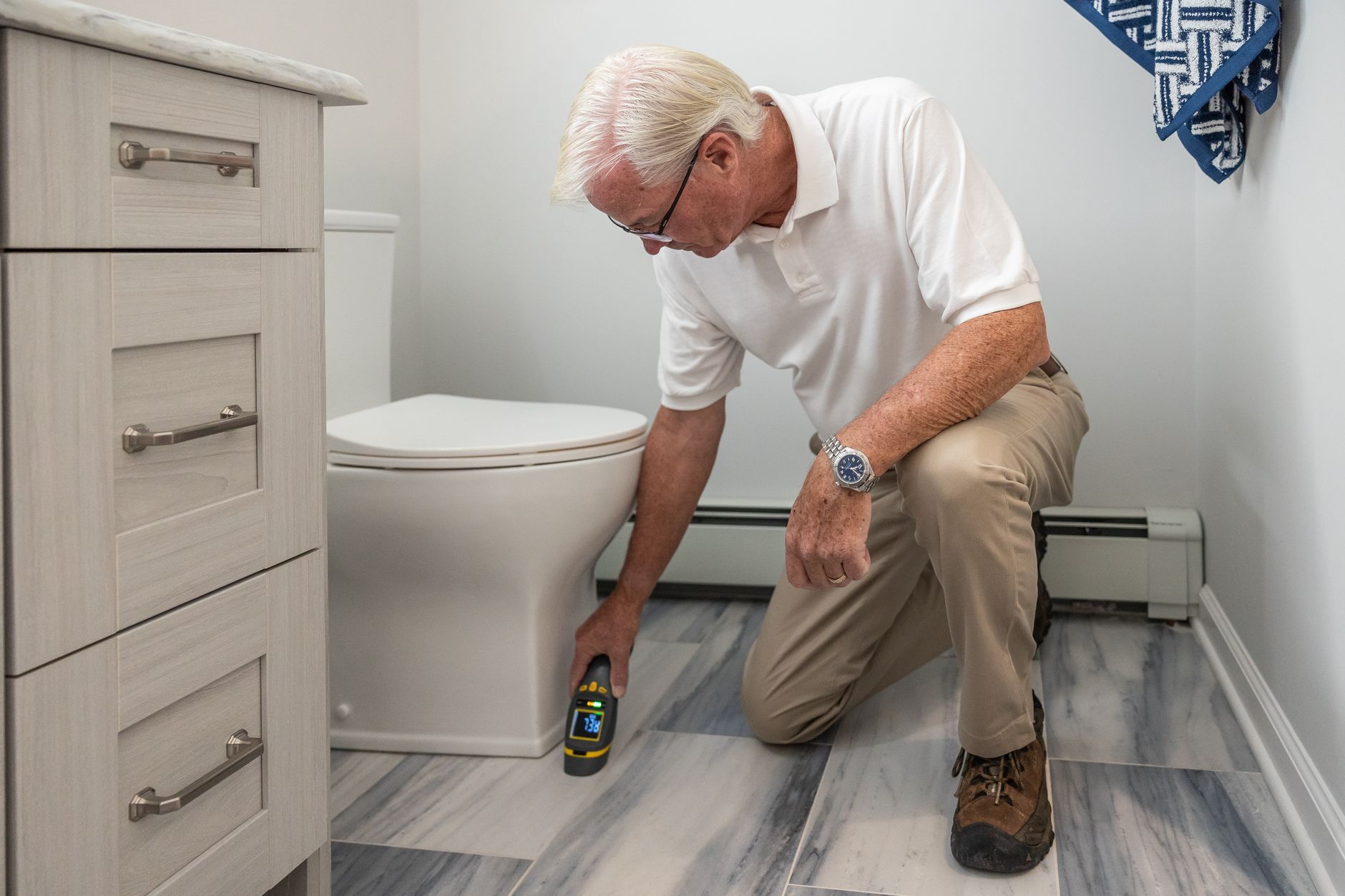Plumber inspecting a residential drainage fixture